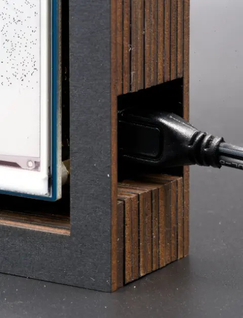 A closeup of the cable entering the device. The layers of cardboard can be clearly seen.