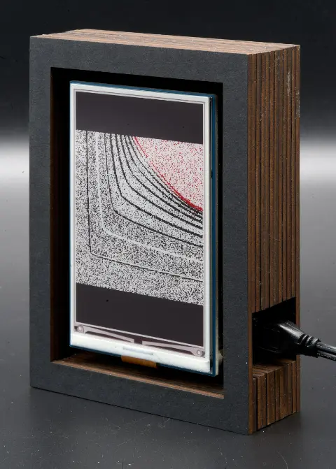 The object, showing black lines on a grey background, and a red blob in the top right corner.