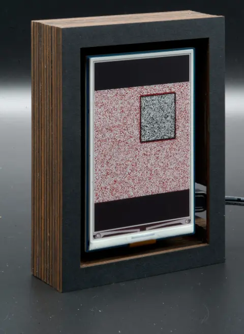 The object, with a grey square on a red background in its screen.
