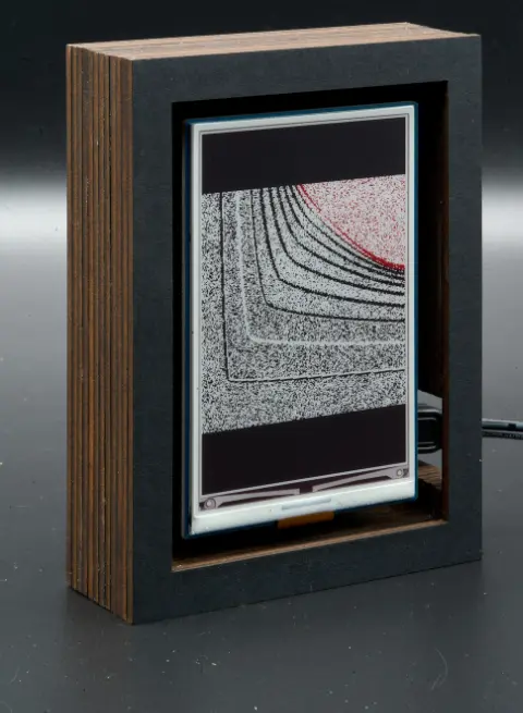 The object, with black lines on a grey background, and a red blob in the top right corner.