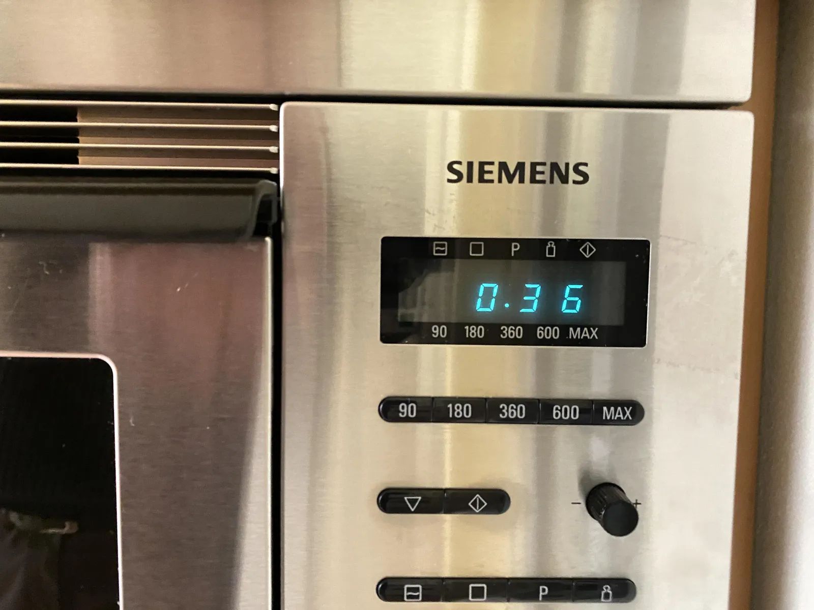 A picture of a detail of a Siemens microwave oven. Some buttons, and a digital clock which says it is 00:36.