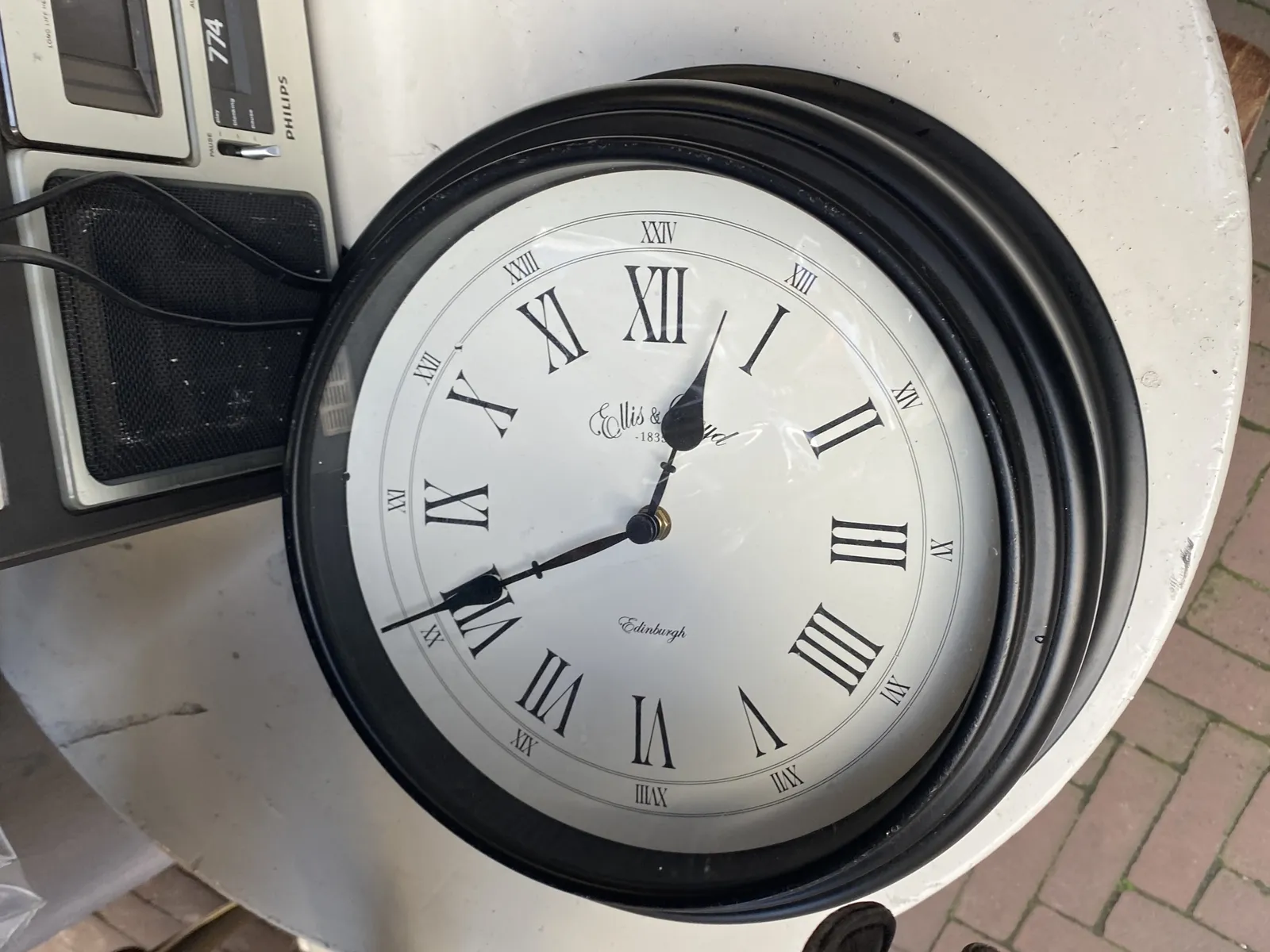 A clock on a table points at 41 minutes past 12.