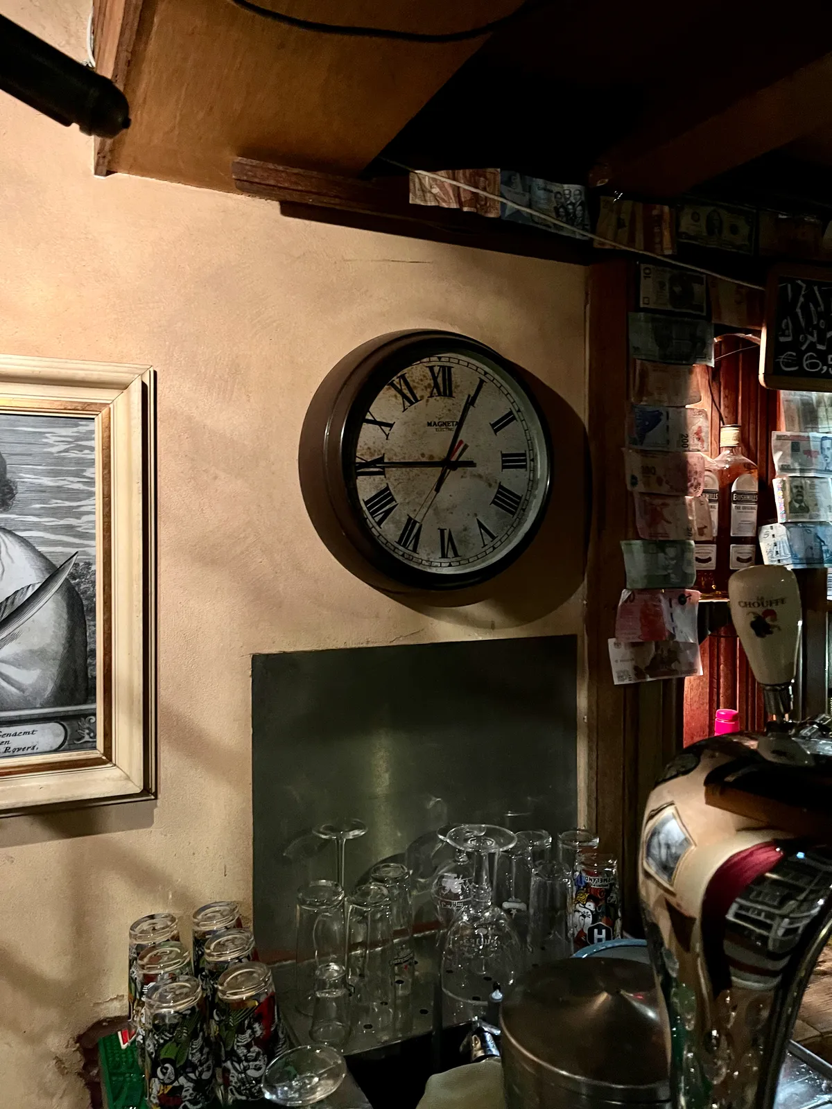 A wall clock in a bar — the Wetering in Amsterdam to be precise. It points at a quarter to one.