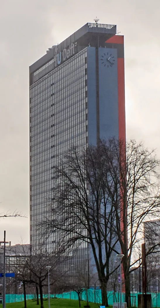 An enormous tower at the Delft University with an enormous clock on it. It points at 22 past one.