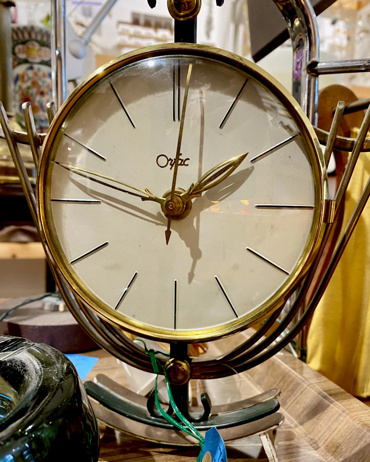 An elegant clock, with nicely shaped hands points at 13 minutes to 2.