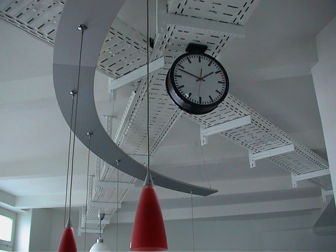 A modernist clock points at twelve minutes to two.