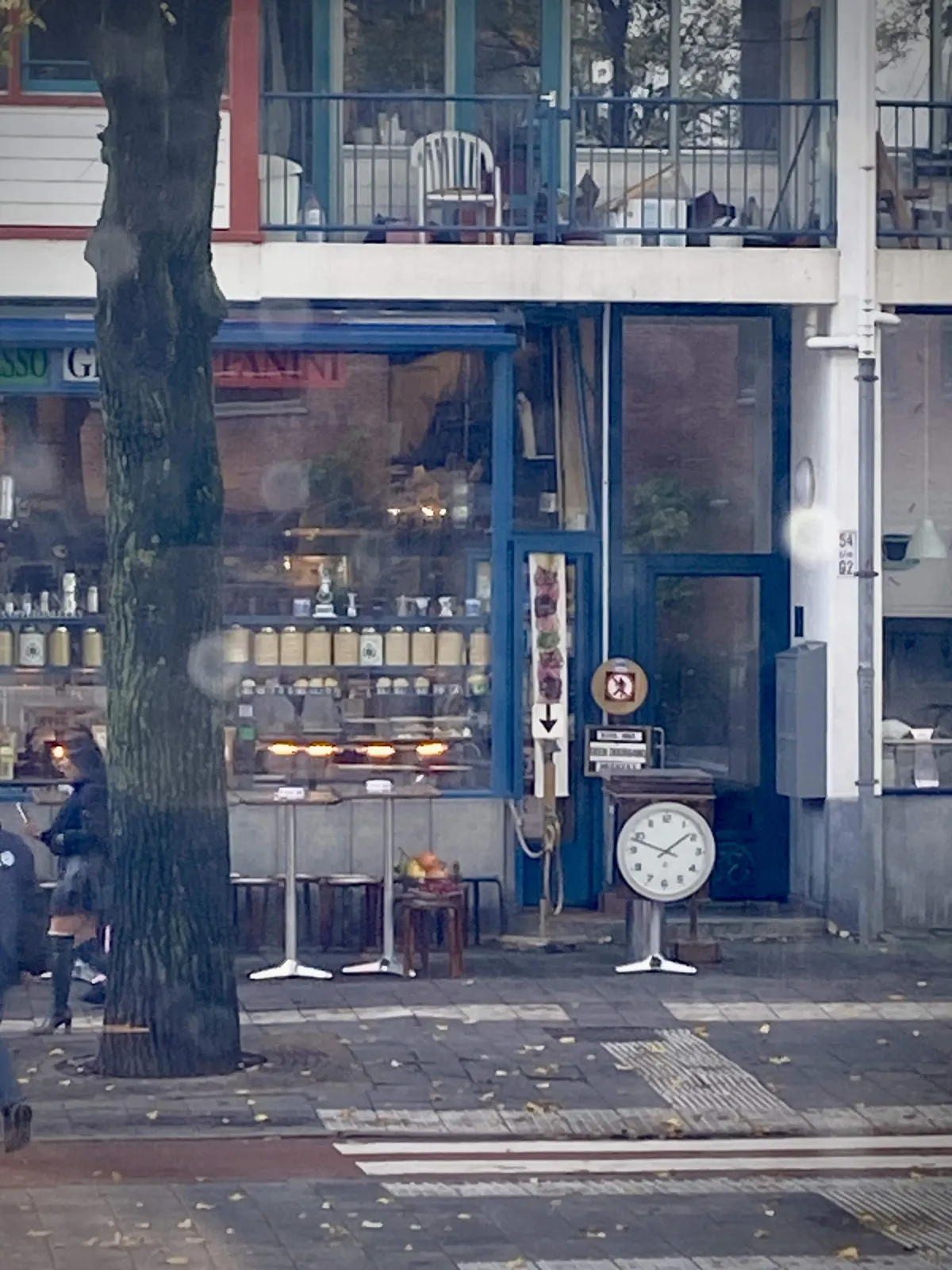 There’s a clock standing outside an Italian restaurant. Yes, it’s a bit weird indeed. On the clock it is 12 minutes to 2.