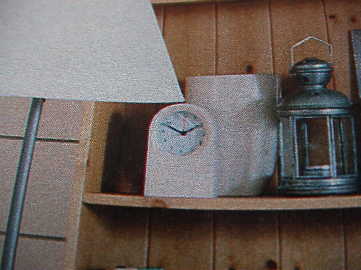 A clock in a magazine points at ten to two.