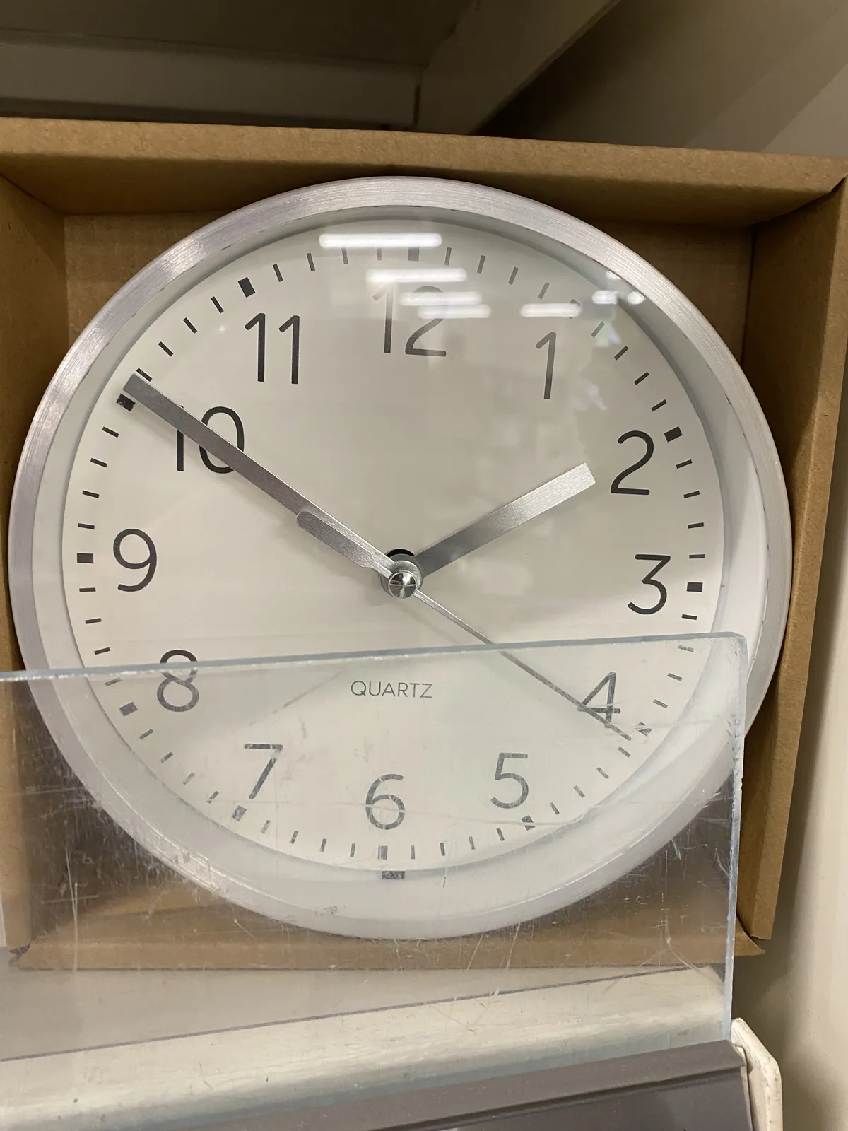 A clock on a box points at 10 minutes to two.