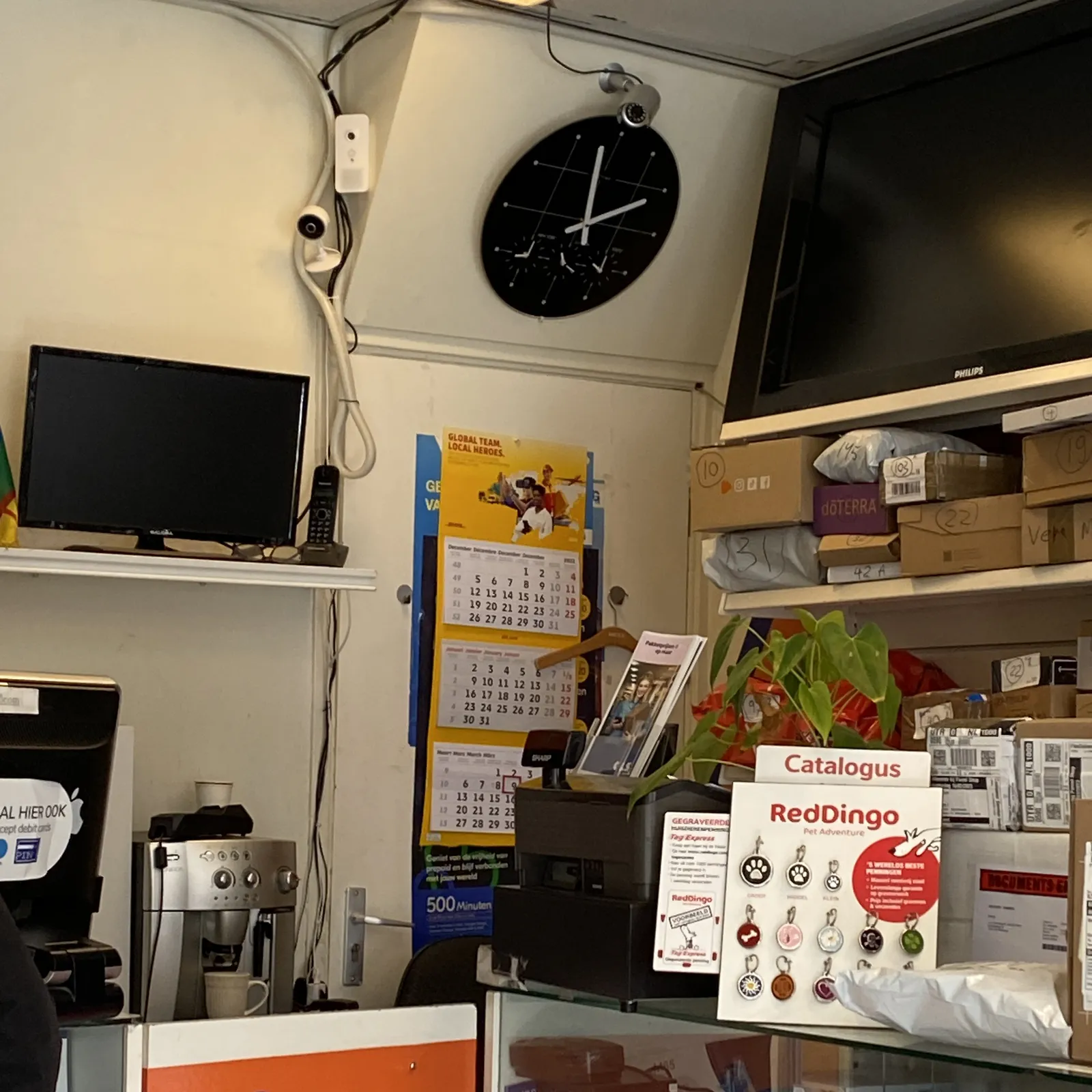 This clock in a rather messy shop points at two minutes to two.