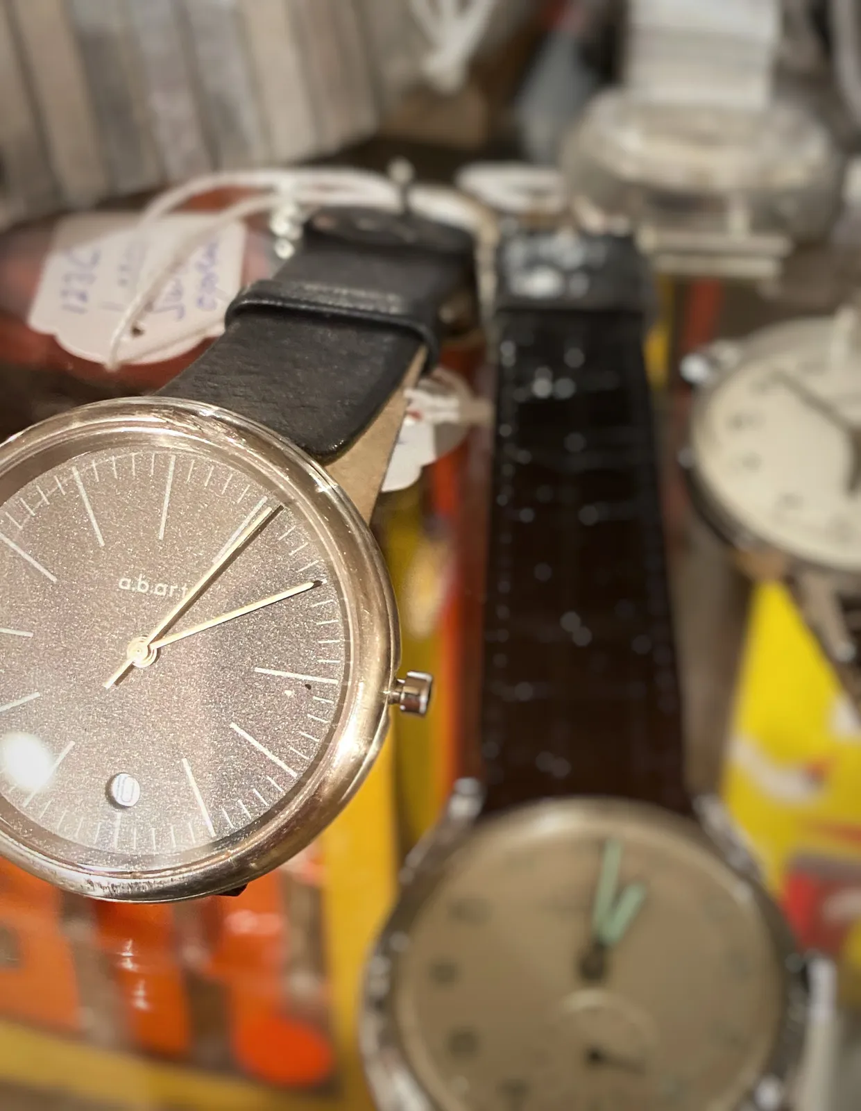 A few wrist watches on display here. Just one of them is clearly in focus. It points at 5 past 2.