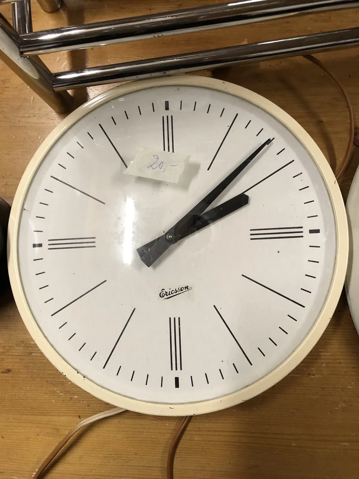 A clock in a thrift shop points at 7 minutes past 2.