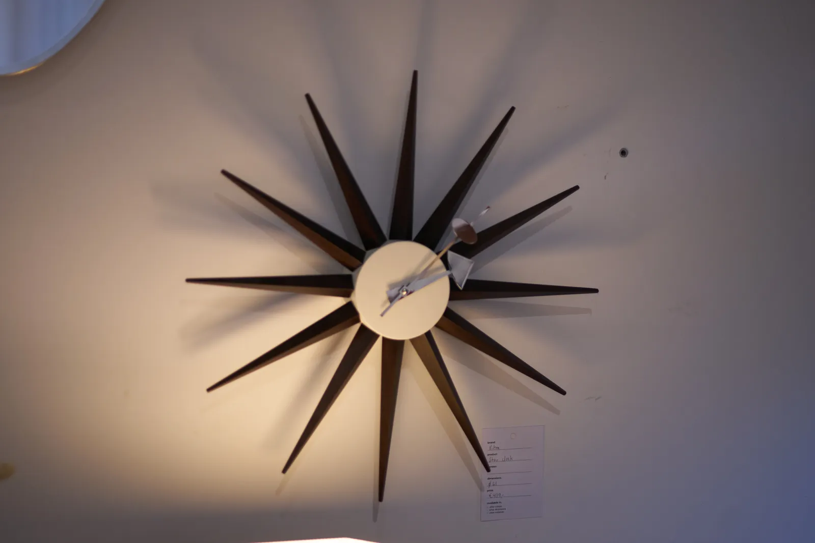 A very starry clock points at approximately 7 past 2.