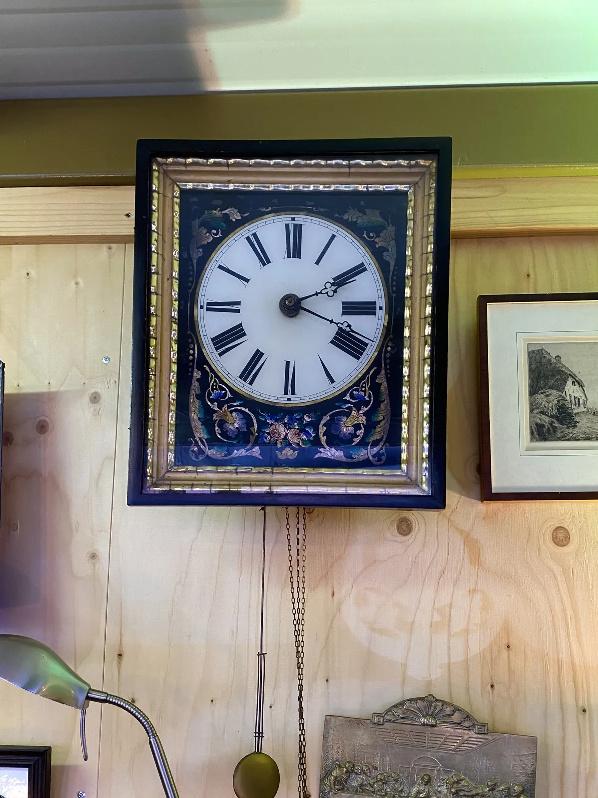 An old, colourful, decorated clock, with roman numerals. It points at 18 minutes past 2.