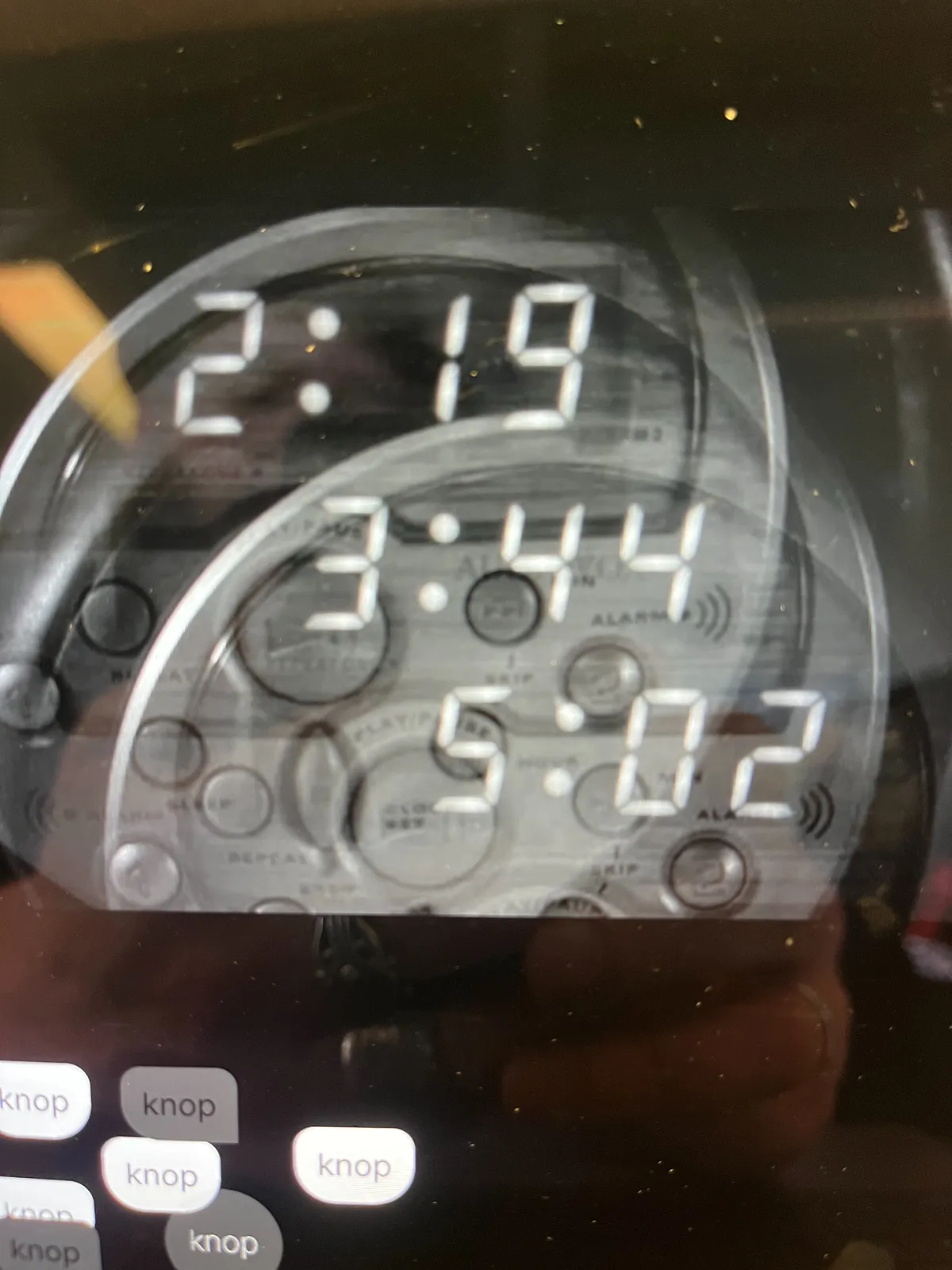 Three superimposed images of the same digital clock, all with a different timestamp. One says it is 2:19, another says it is 2:44 and the last one says it is 5:02