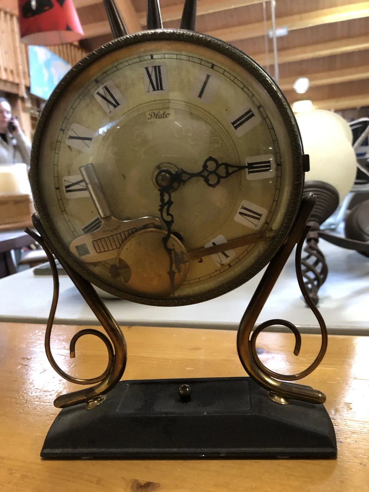 This old clock is a bit of a mess. There are two keys in it, probably for winding it up and for changing the time. There’s a name printed on it: Plato. So could this be the quintessential image of a clock? I doubt it. The hour hand almost points at three, yet the minute hand points down. It could be because of gravity. This makes it a bit hard to read the time. Let’s assume it is half past two.
