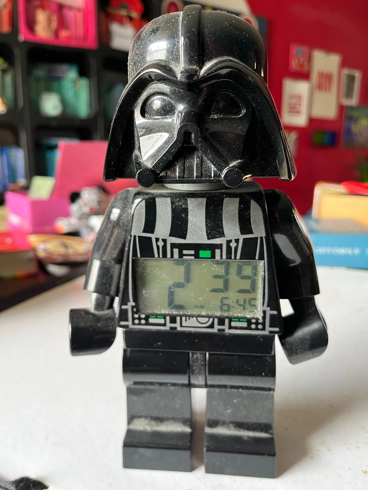 A rather large Lego figure, styled like Darth Vader from star wars. There’s  a clock built into its belly. The clock says it is 2:39