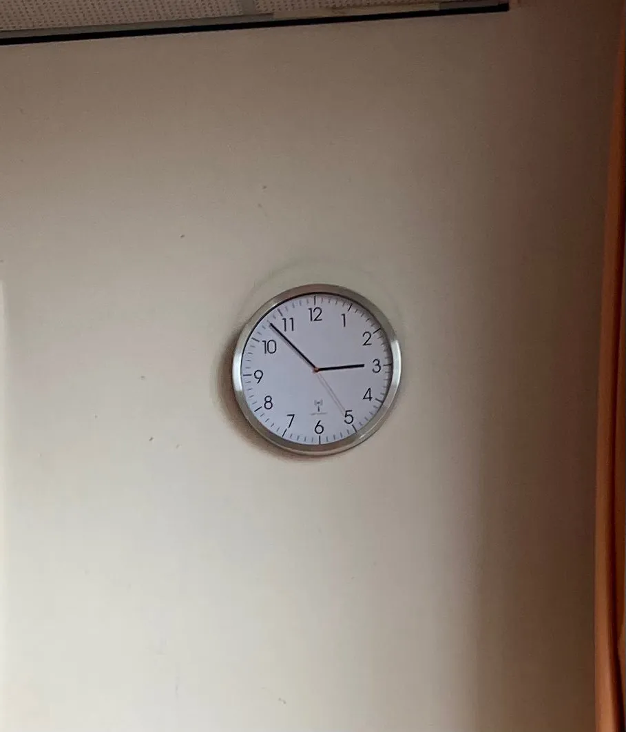 At first this seems like a rather boring picture of a rather normal clock on a white wall. But if you look at the dust shade on the wall you can see that this clock used to hang five centimeters higher. The clock points at 7 minutes to 3.