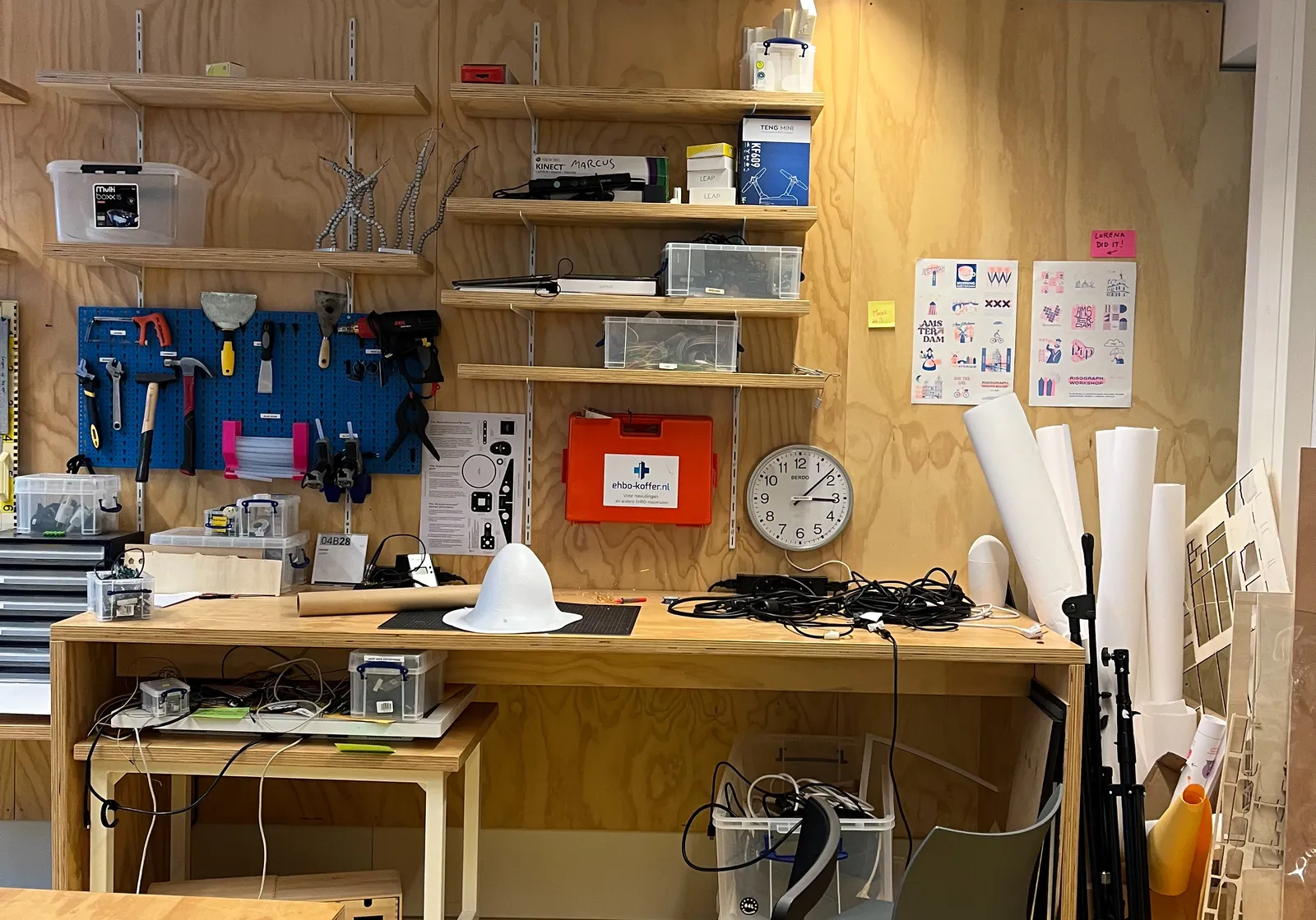 A workshop with all kinds of tools. And a clock on the wall that points at 8 minutes past 3.
