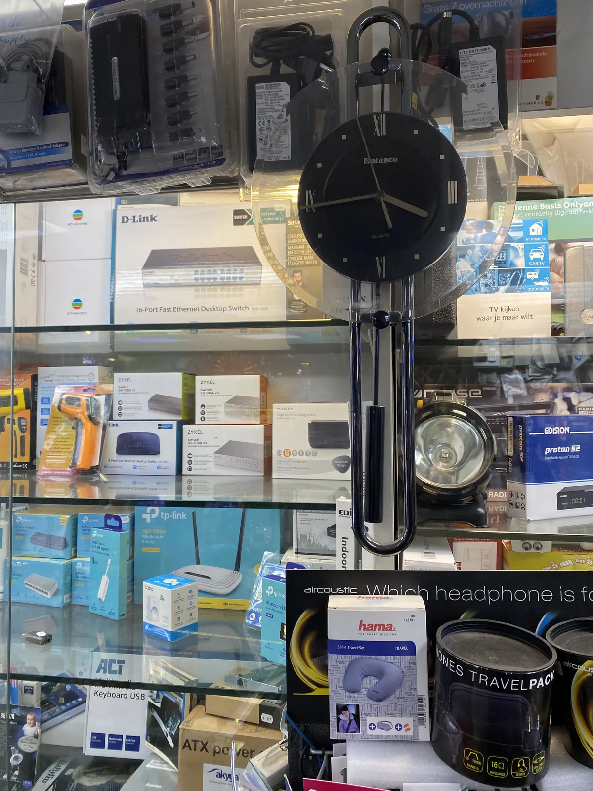 In an electronics shop there’s a clock. It points at 16 minutes to 4.