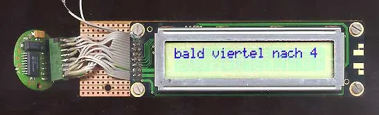 A digital device says Bald viertel nach 4, which means almost a quarter past four in German.