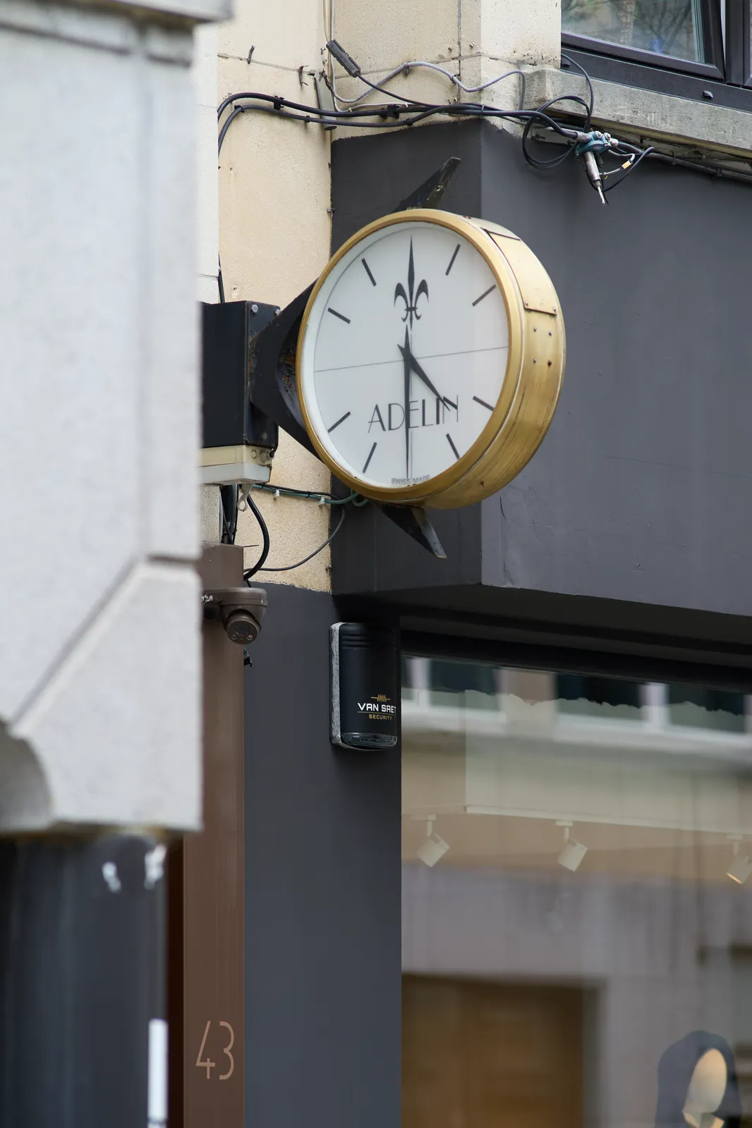 A clock attached to a facade. It points at four thirty