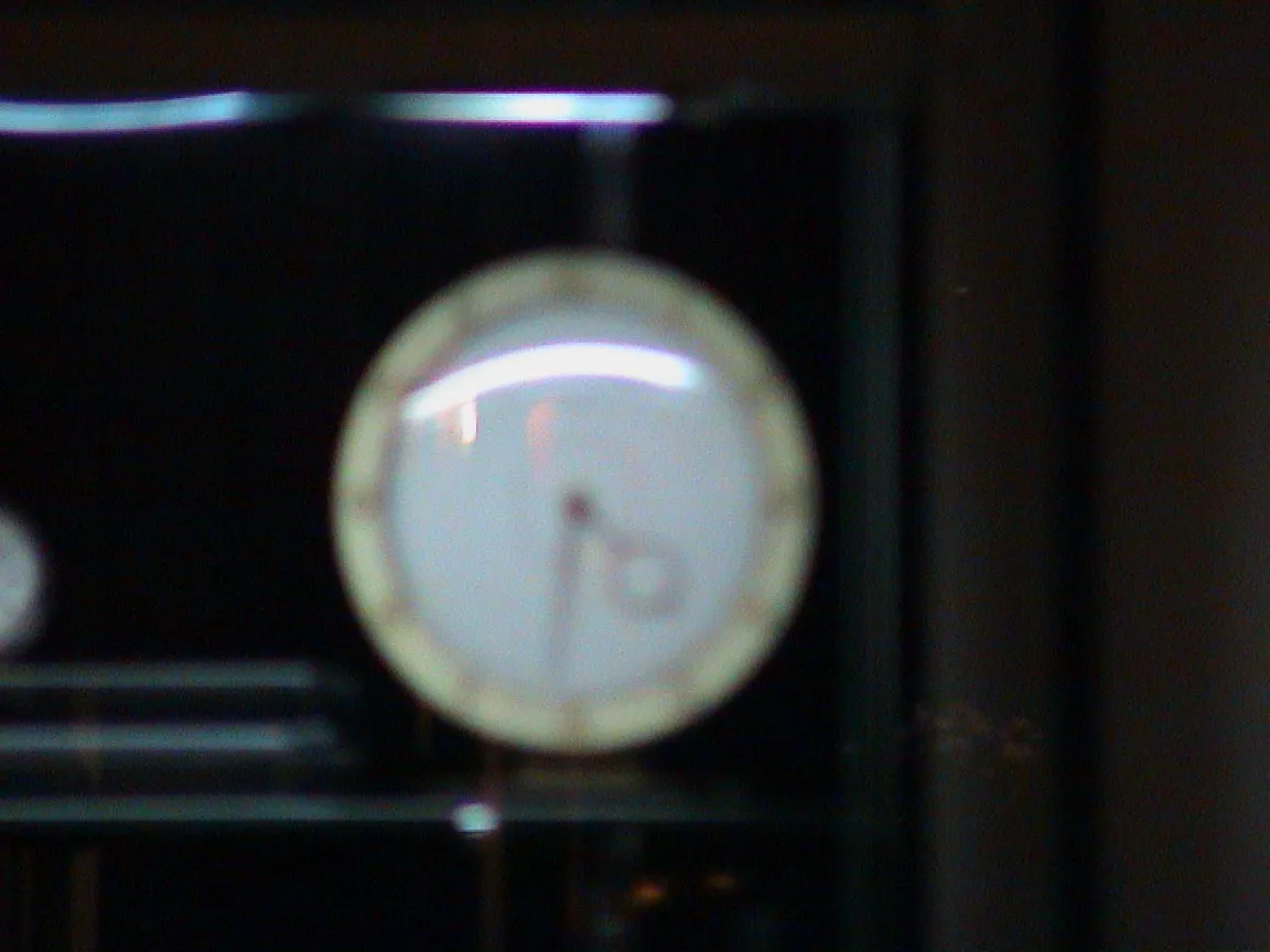 It is a bit hard to see, but this blurry clock points at 31 minutes past 4.