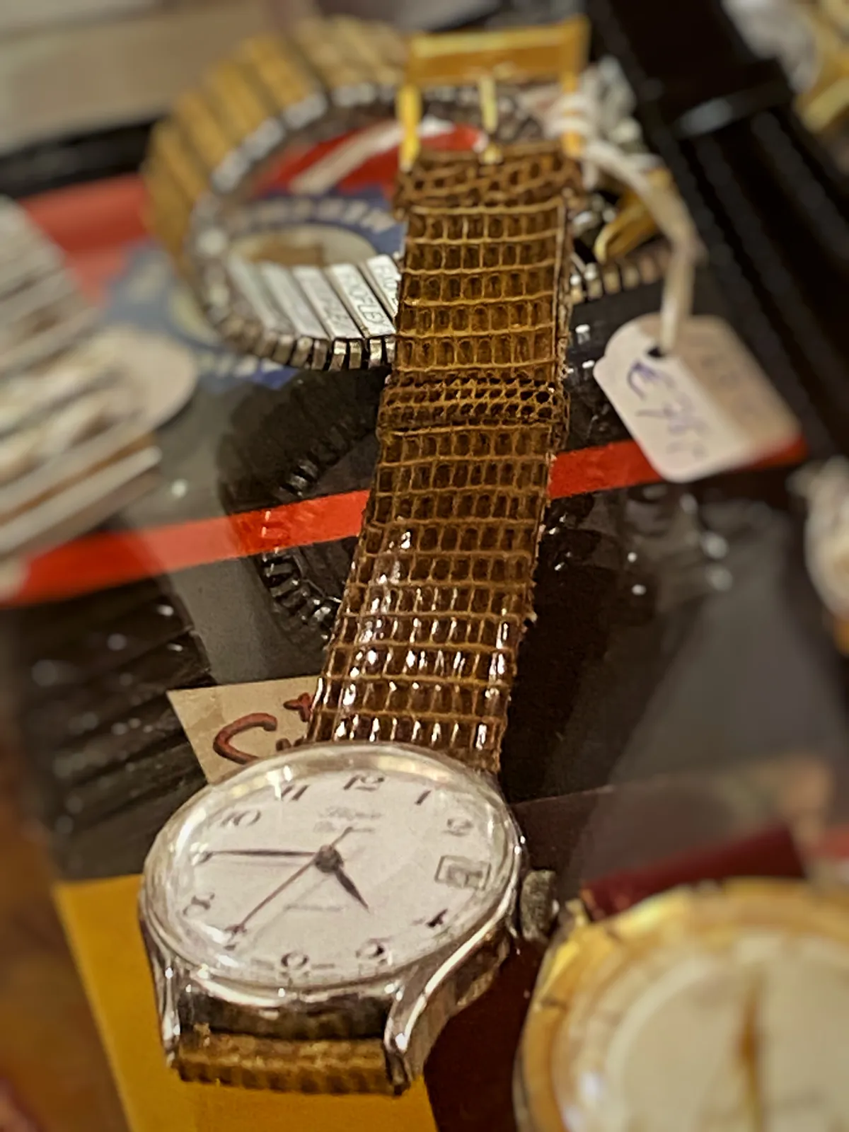 A few clocks for sale, but just one is clearly in focus. It points at a quarter to 5.