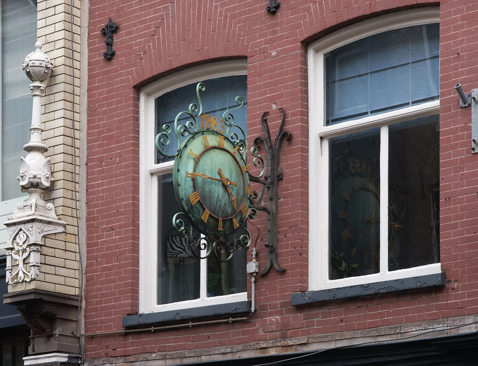 According to this old clock (the number 1883 is attached to it, and it looks bronze) in an old shopping street in Amsterdam it is a quarter to five.