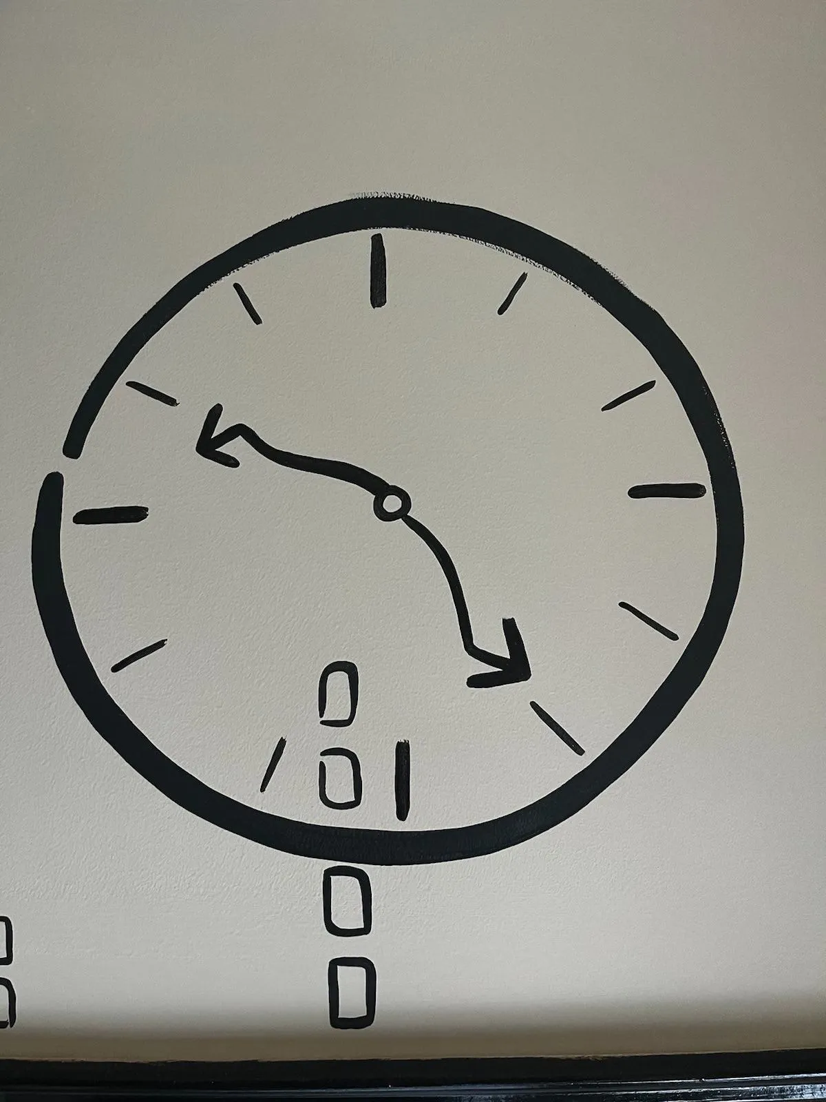 A hand drawn clock on this wall. The hands are rather wavy. In a way they seem to be pointing at 12 minutes to 5.