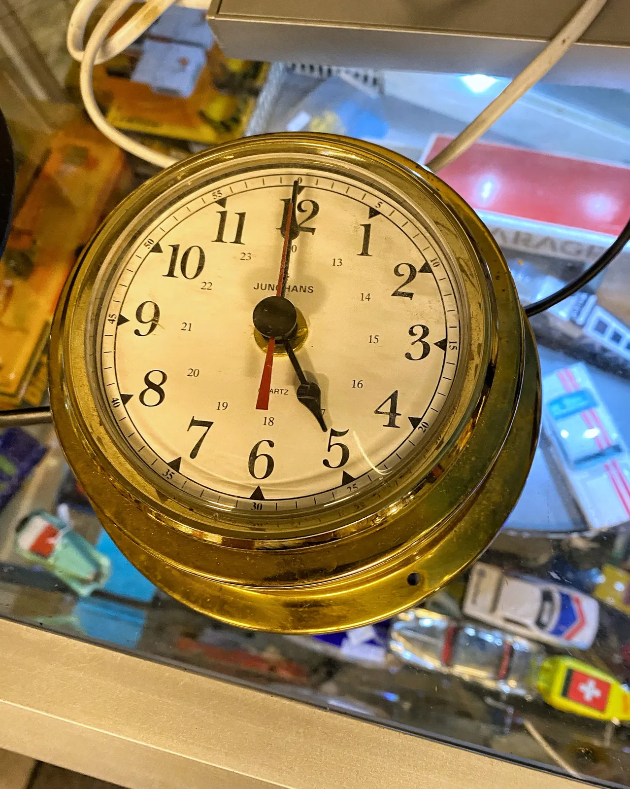 This looks like a rather heavy brass clock. It points at one minute to 5.