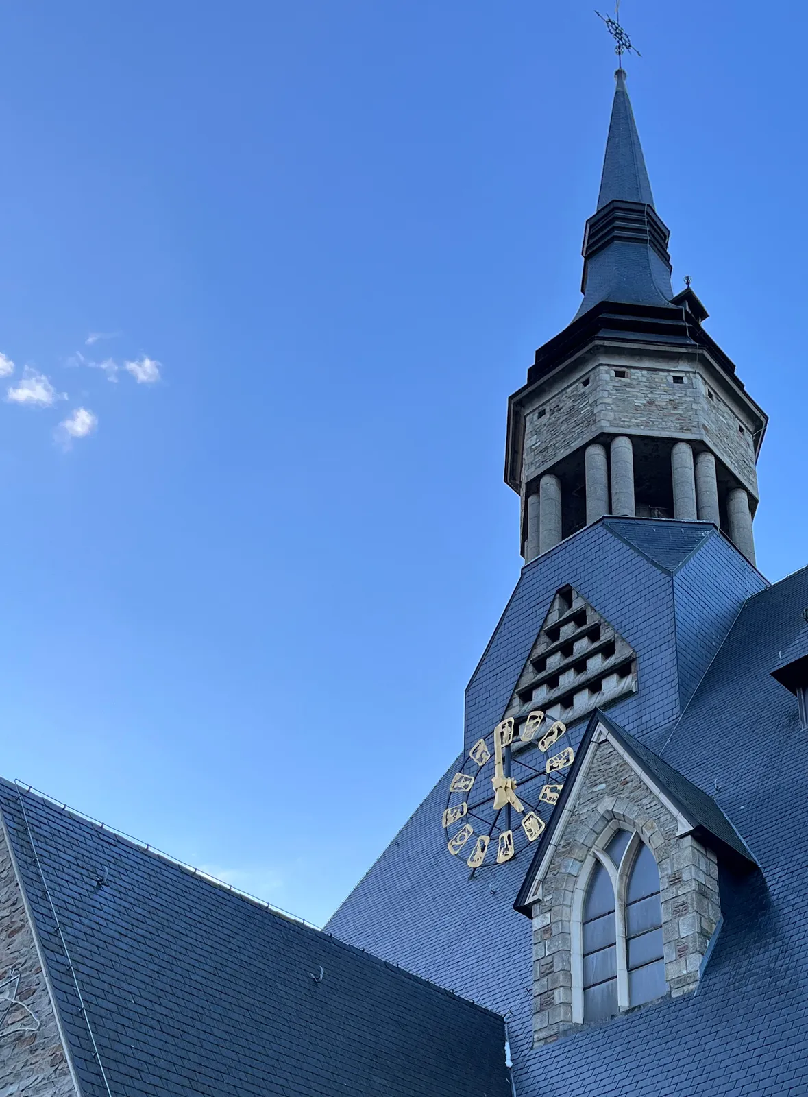 The clock on a church in Vielsalm points at one minute before five.
