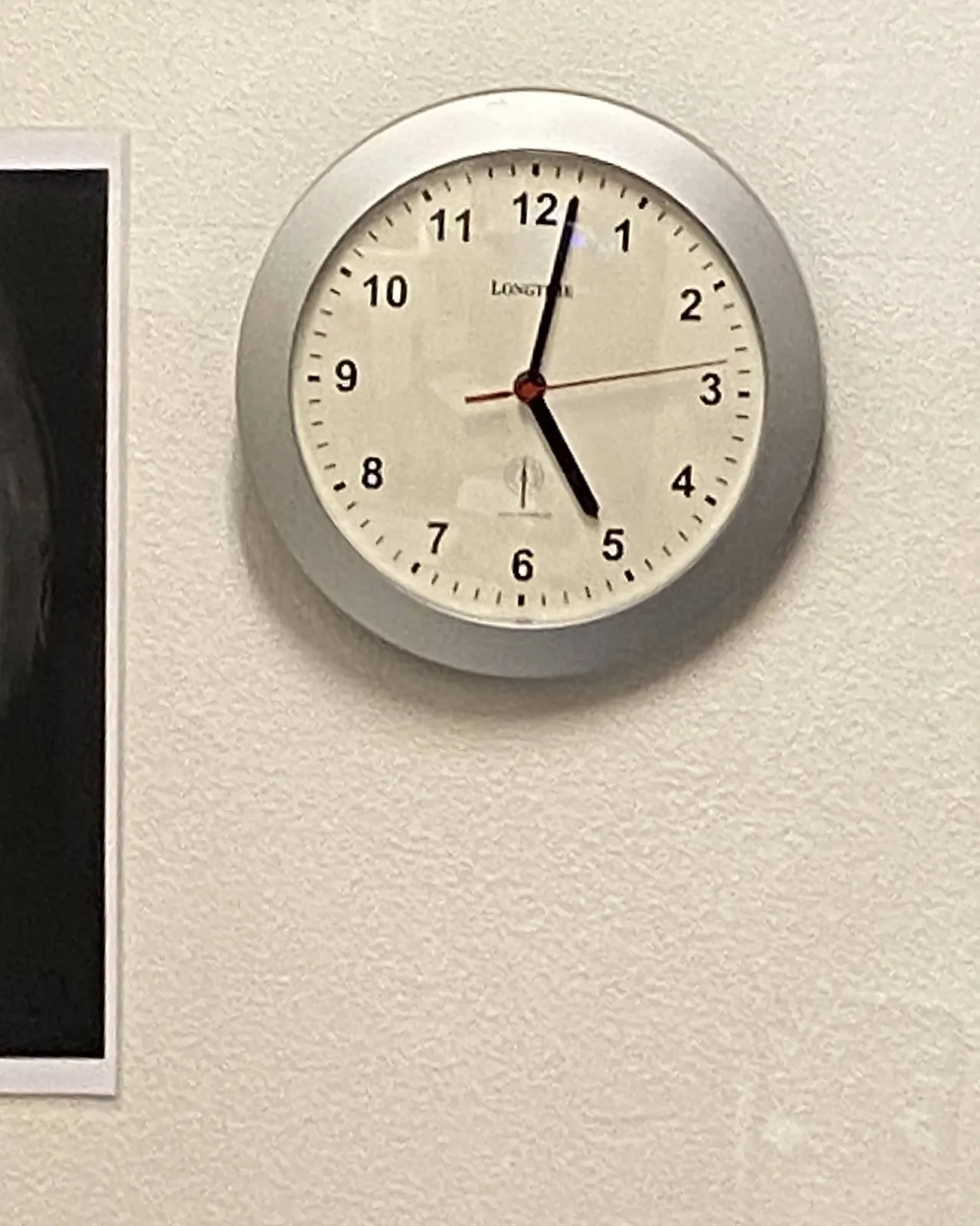 A clock. It points at 2 minutes past 5.