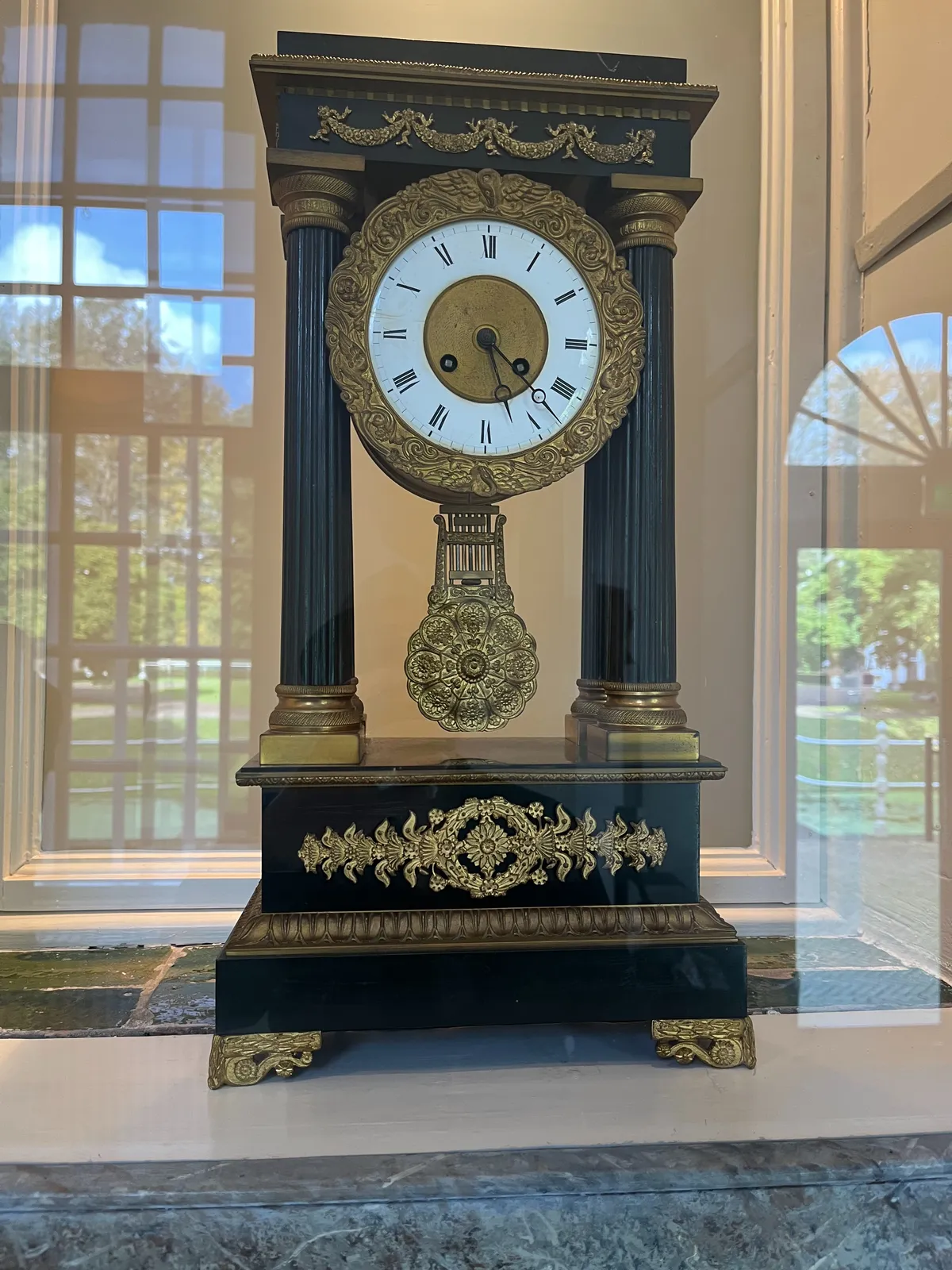 A monumental, rather large, black and gold neo classical mantel clock, richly ornamented. It points at 22 minutes past 5.