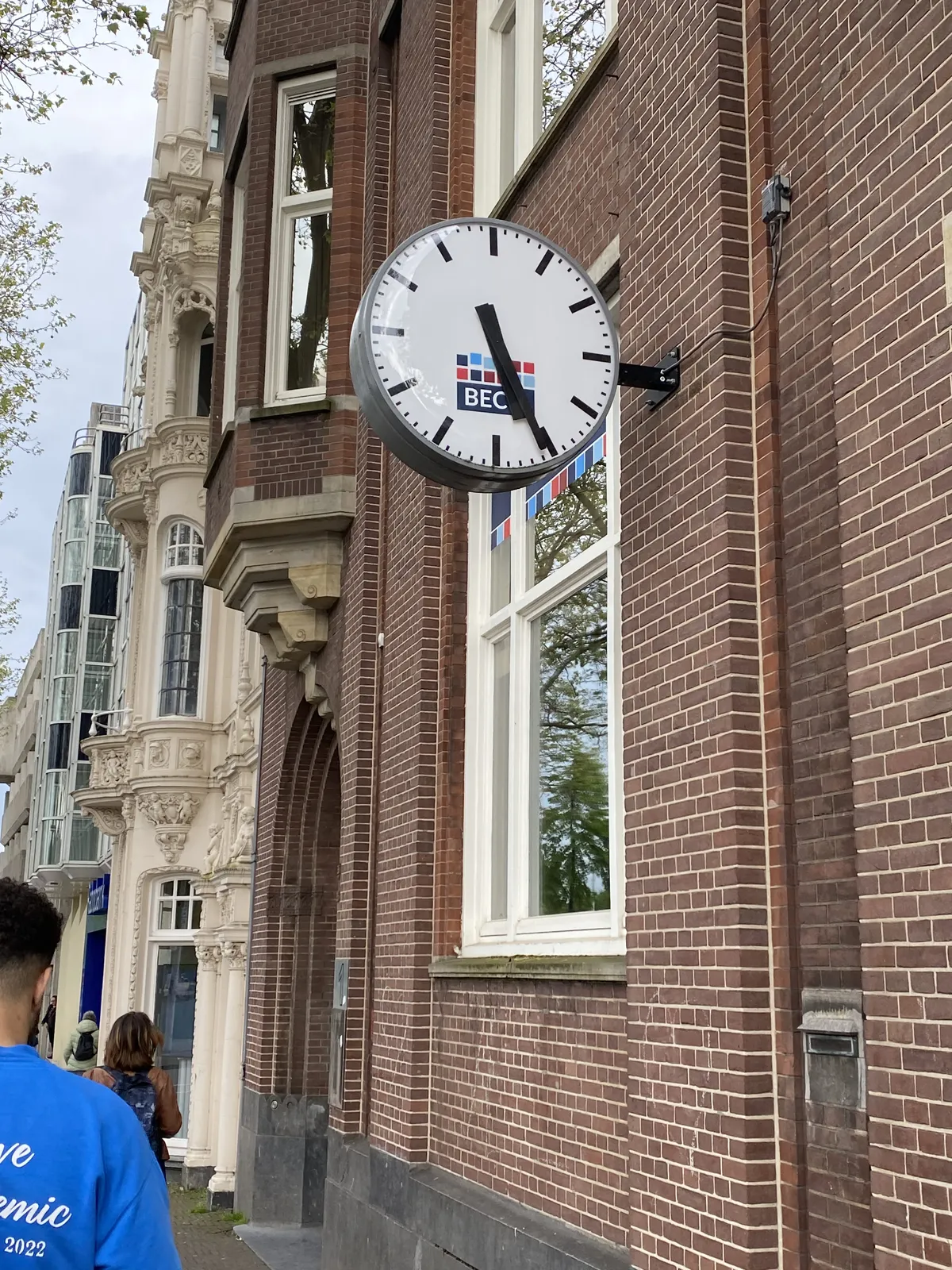 A clock attached to a wall. It points at 5:25.