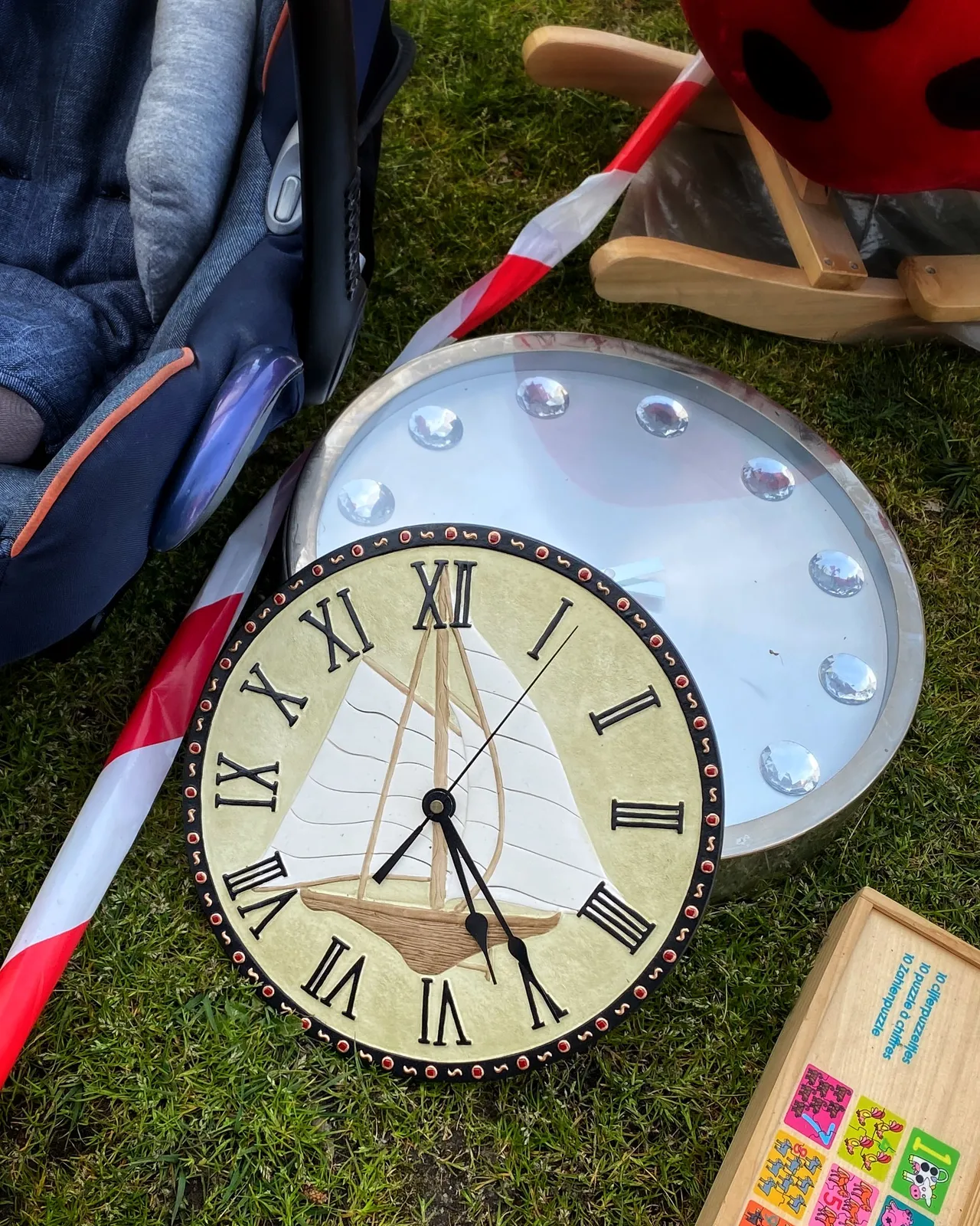 Two clocks for sale. On one of them the time can be seen. It is 25 past 5.
