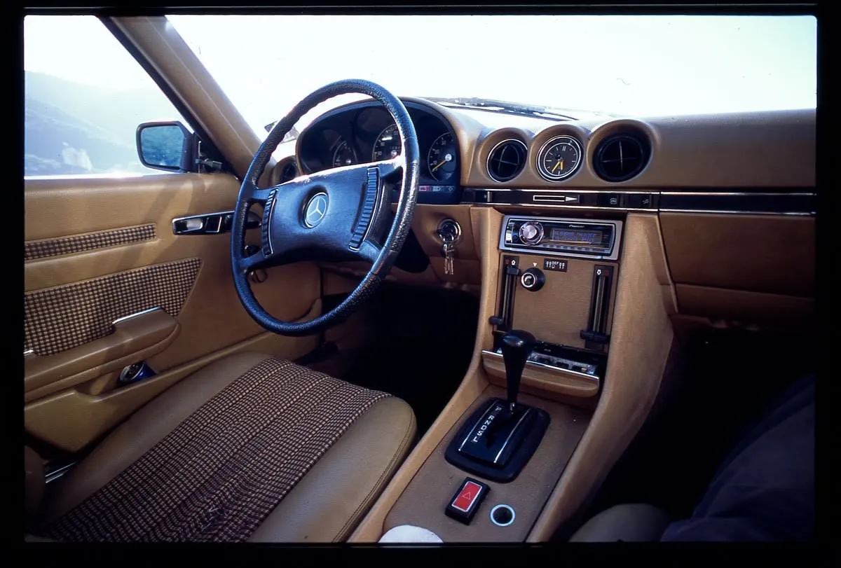 The clock in the middle of the dashboard of this 1972 Mercedes SLC says it is 5:35.