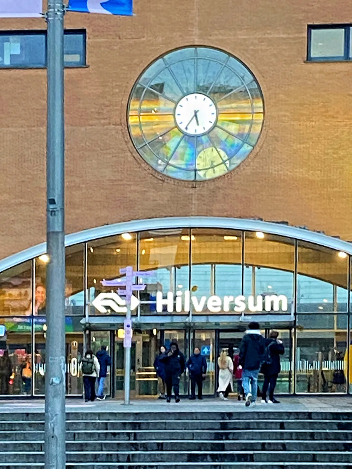 The clock in the facade of the Hilversum Train Station points at 24 minutes to 6.