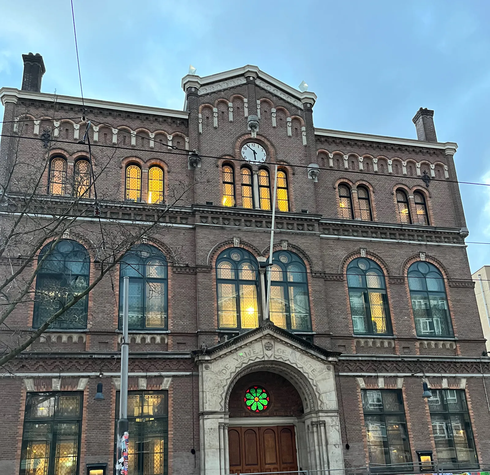 The clock on the Paradiso in Amsterdam points at six minutes to six.