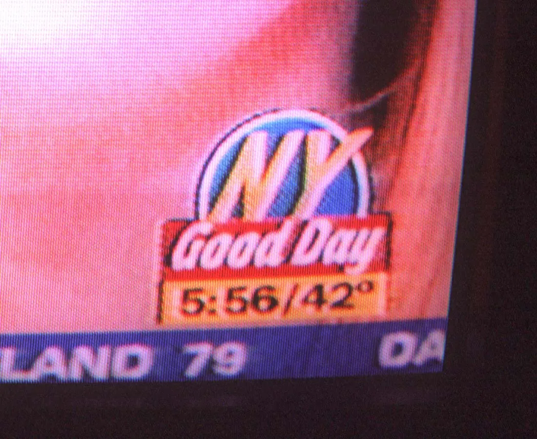 A picture of the corner of a TV screen wishes New York a good day, and it says it is 05:56