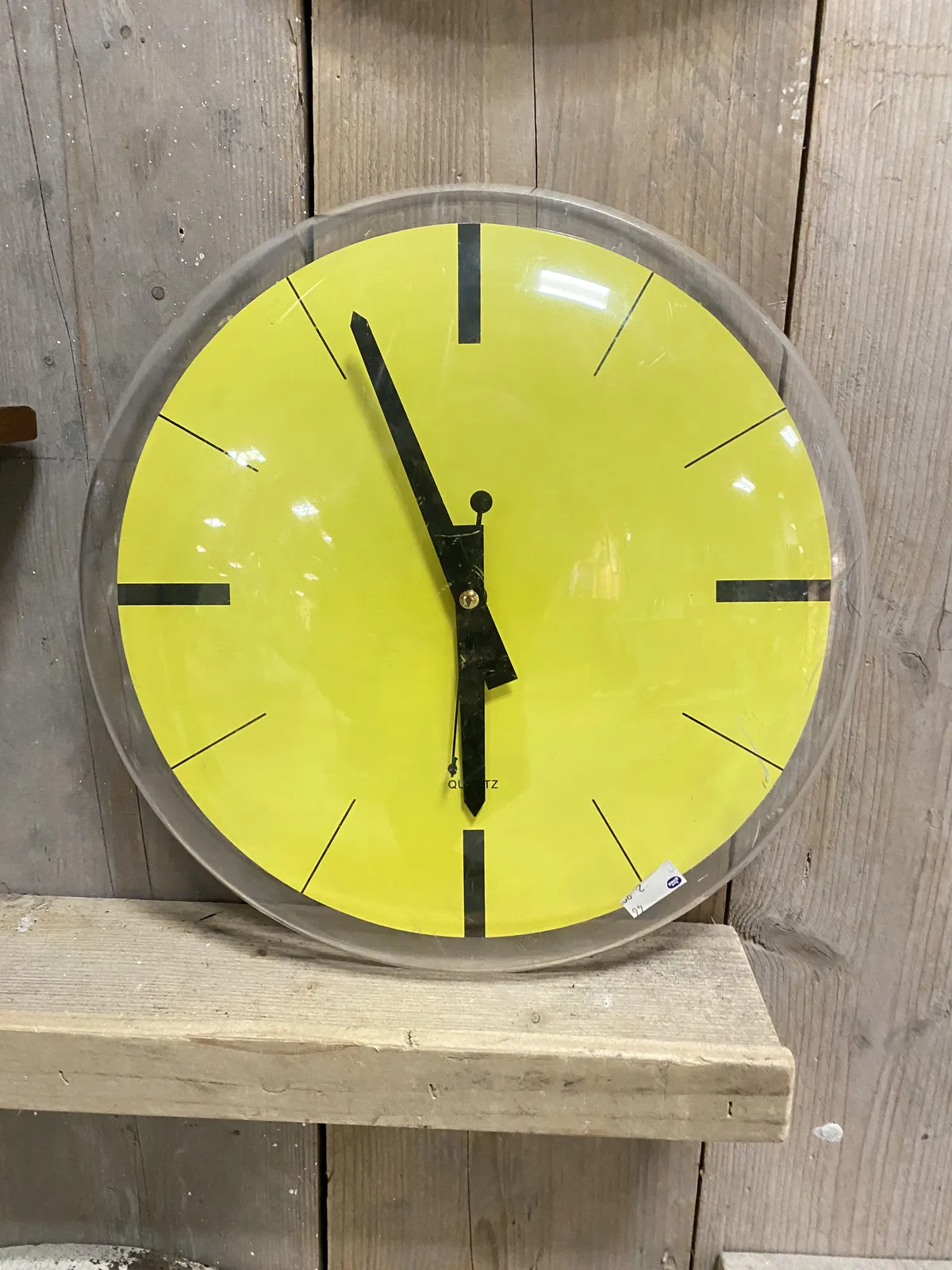 A very bright yellow clock points at 4 minutes to 6.