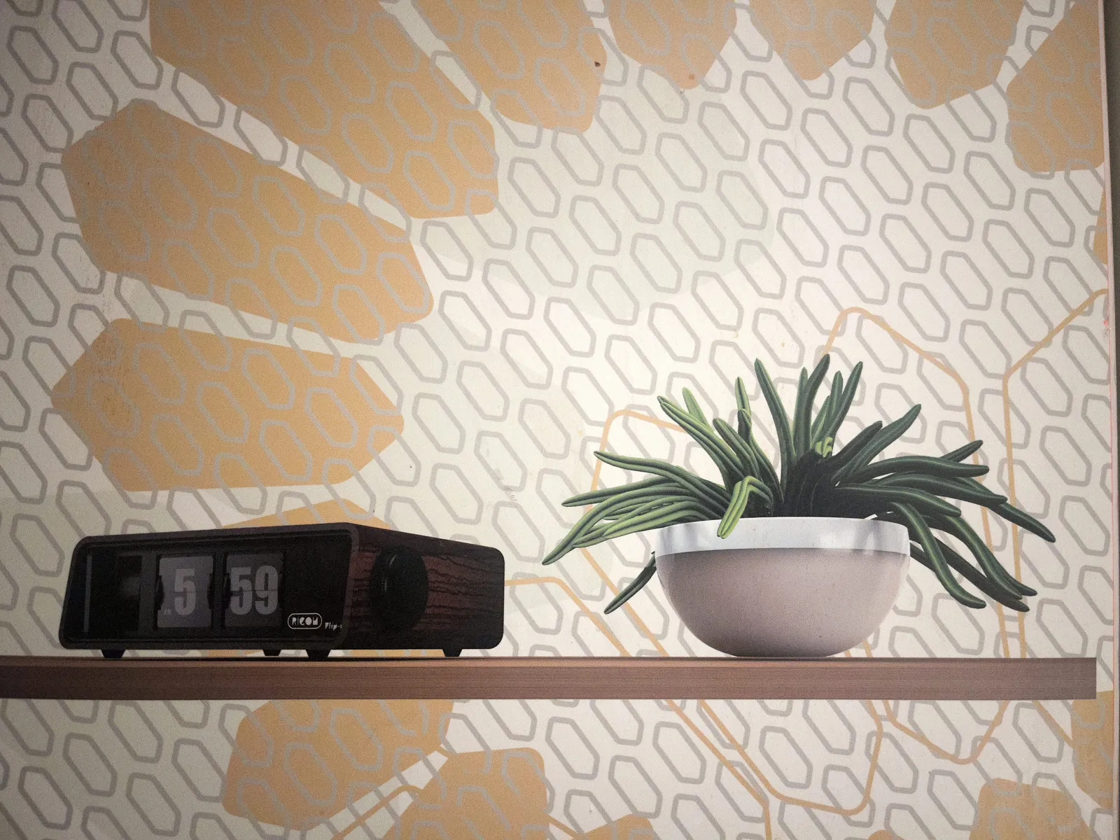 A picture of a plant and a flip clock on a shelf, with a geometrically patterned wallpaper. The flip clock says that it is 1 minute to six.