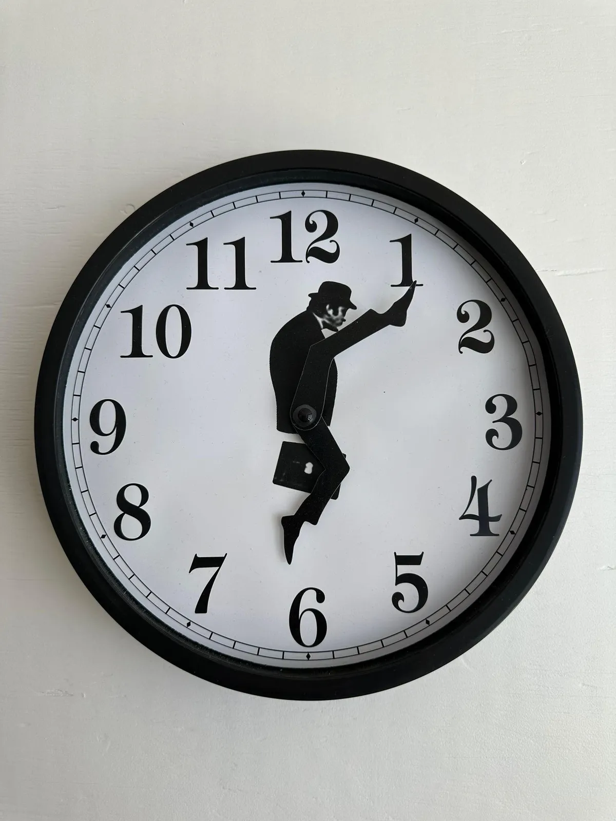 This clock doesn’t have hands, but legs. More specific, they are John Cleese’s legs from the Monthy Pythin sketch about the Ministry of Silly Walks. The feet point at 6 minutes past 6.
