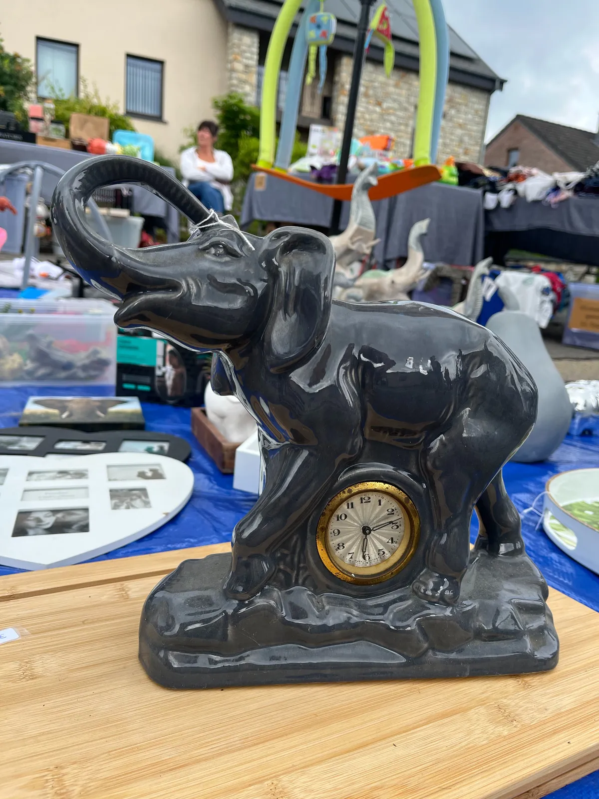 A statue of an elephant with a clock between its legs. It points at 13 minutes past 6.