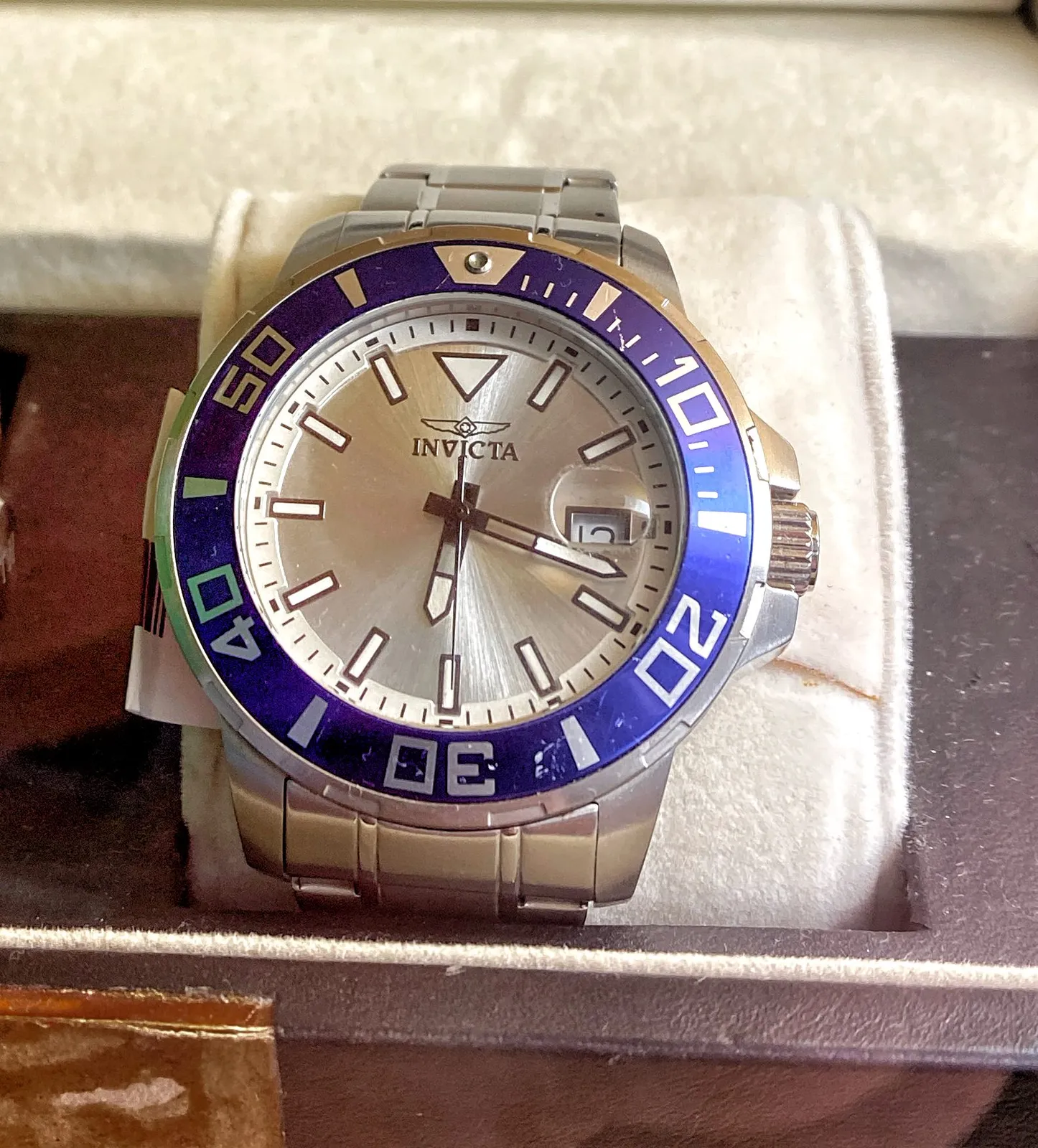 An Invicta wrist watch. It points at 18 past 6.