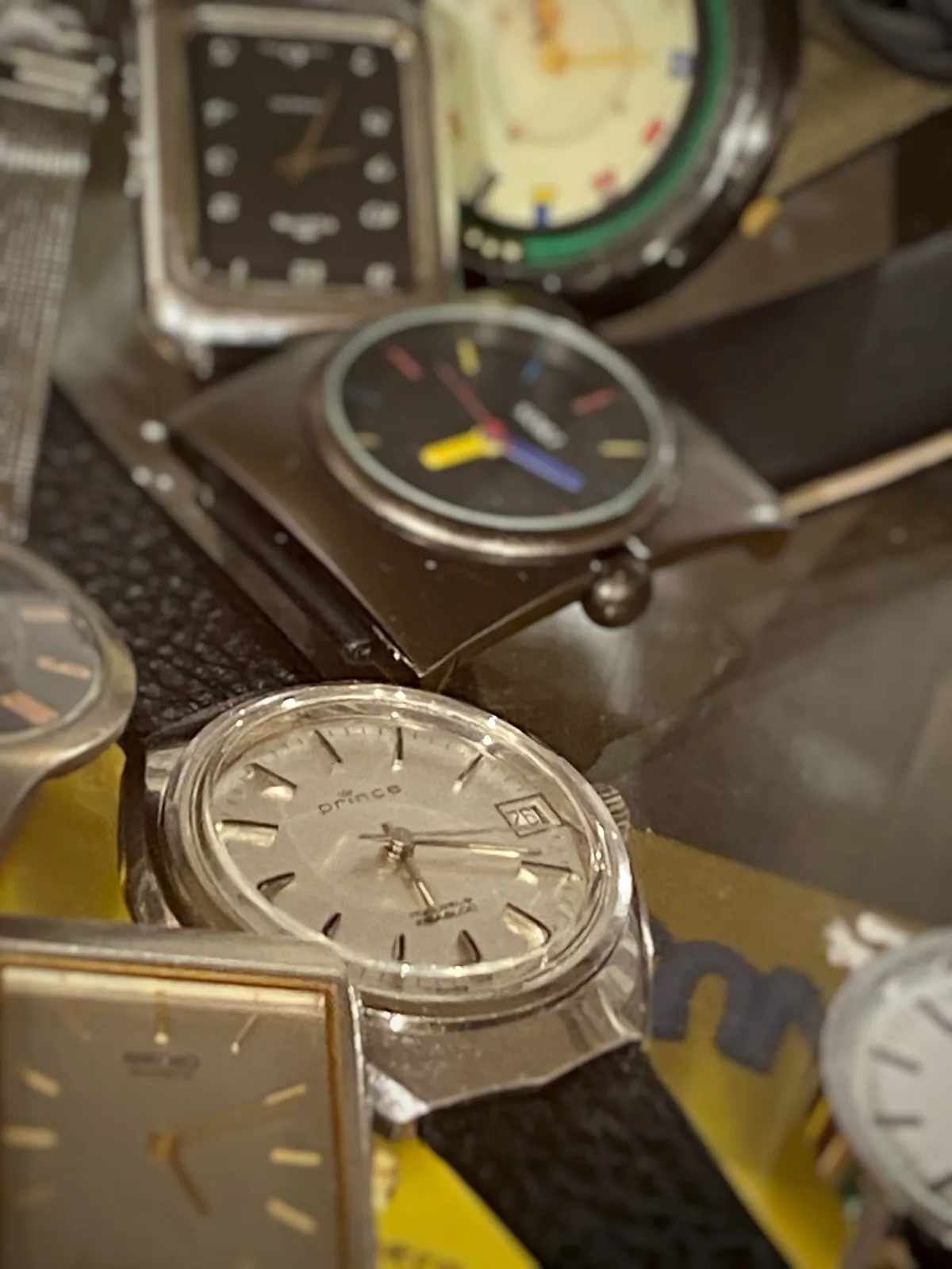 A collection of second hand watches. One of them is clearly in focus. It bears the moniker Prince, and it points at 19 minutes past 6. 