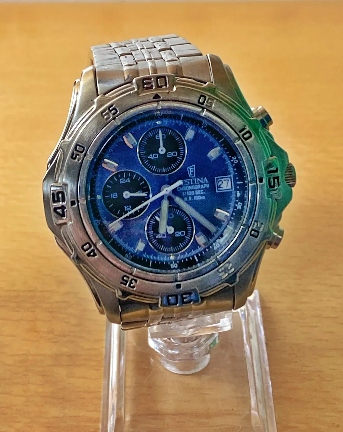 A Festina Chronograph with a blue face in a silver watch. It points at 22 past 6.