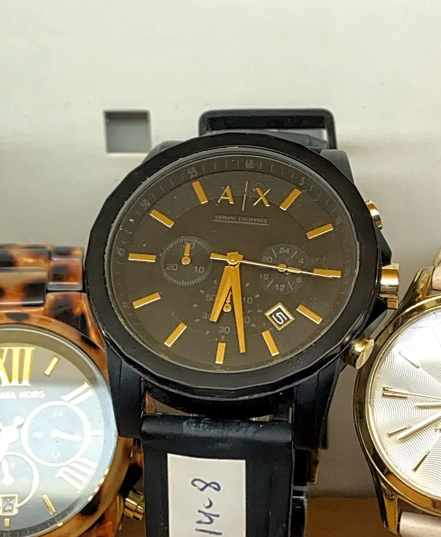 An Armani Exchange watch. It points at 28 past 6.