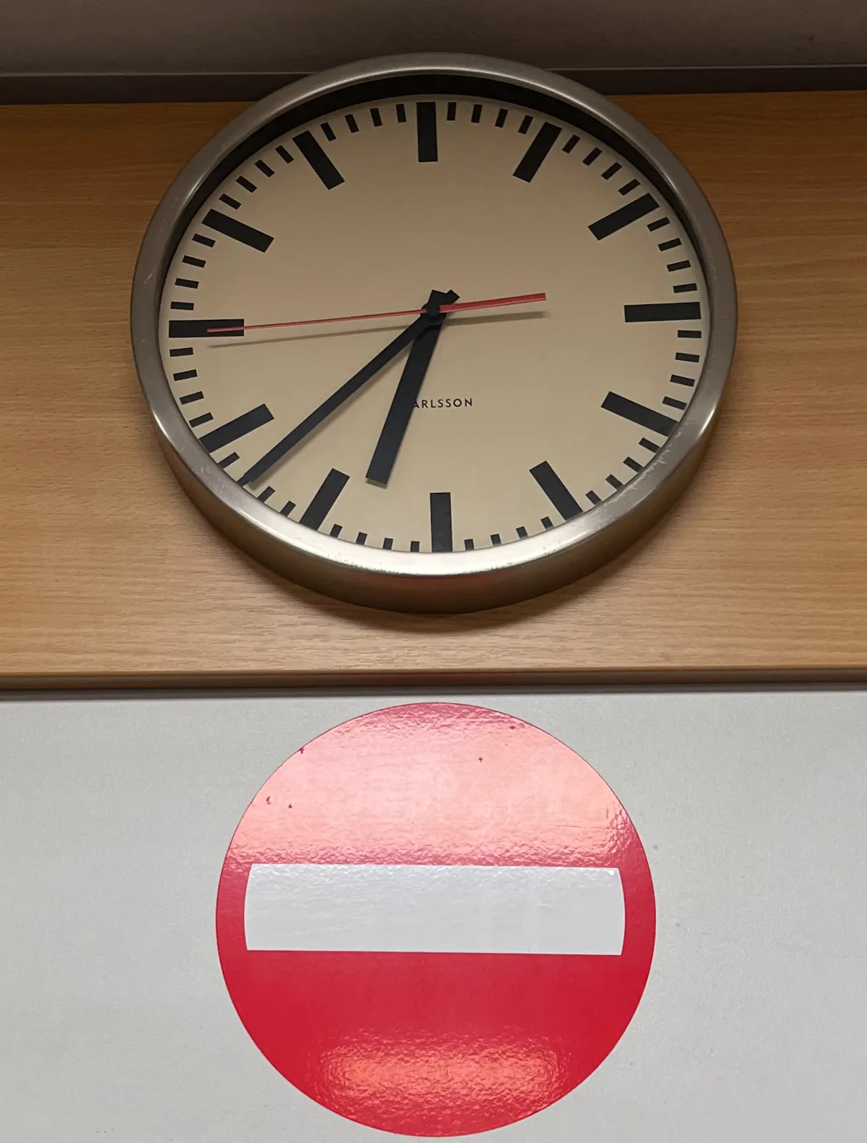 Right above this No Entry sign there’s a clock that points at 38 past six.