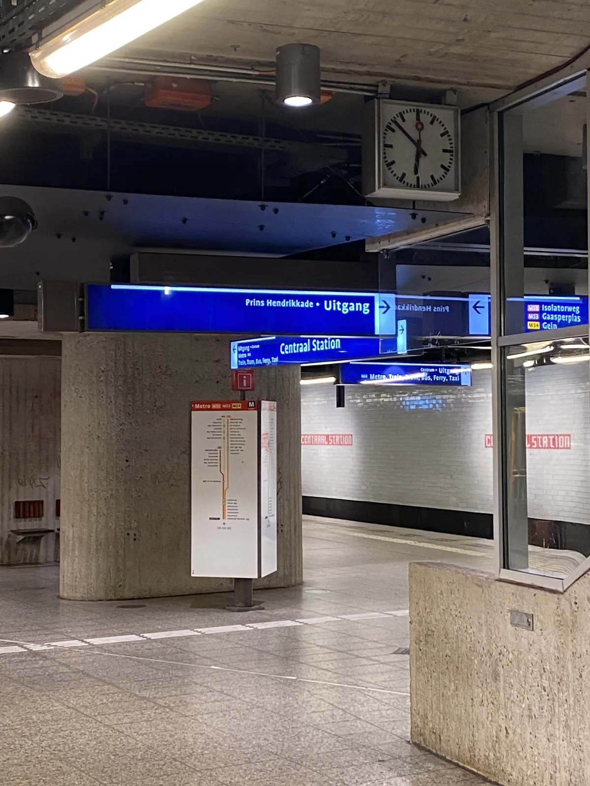 There’s lots of signage in the picture, pointing in all kinds of directions. There’s also a clock that seems to point at 8 minutes to 7.